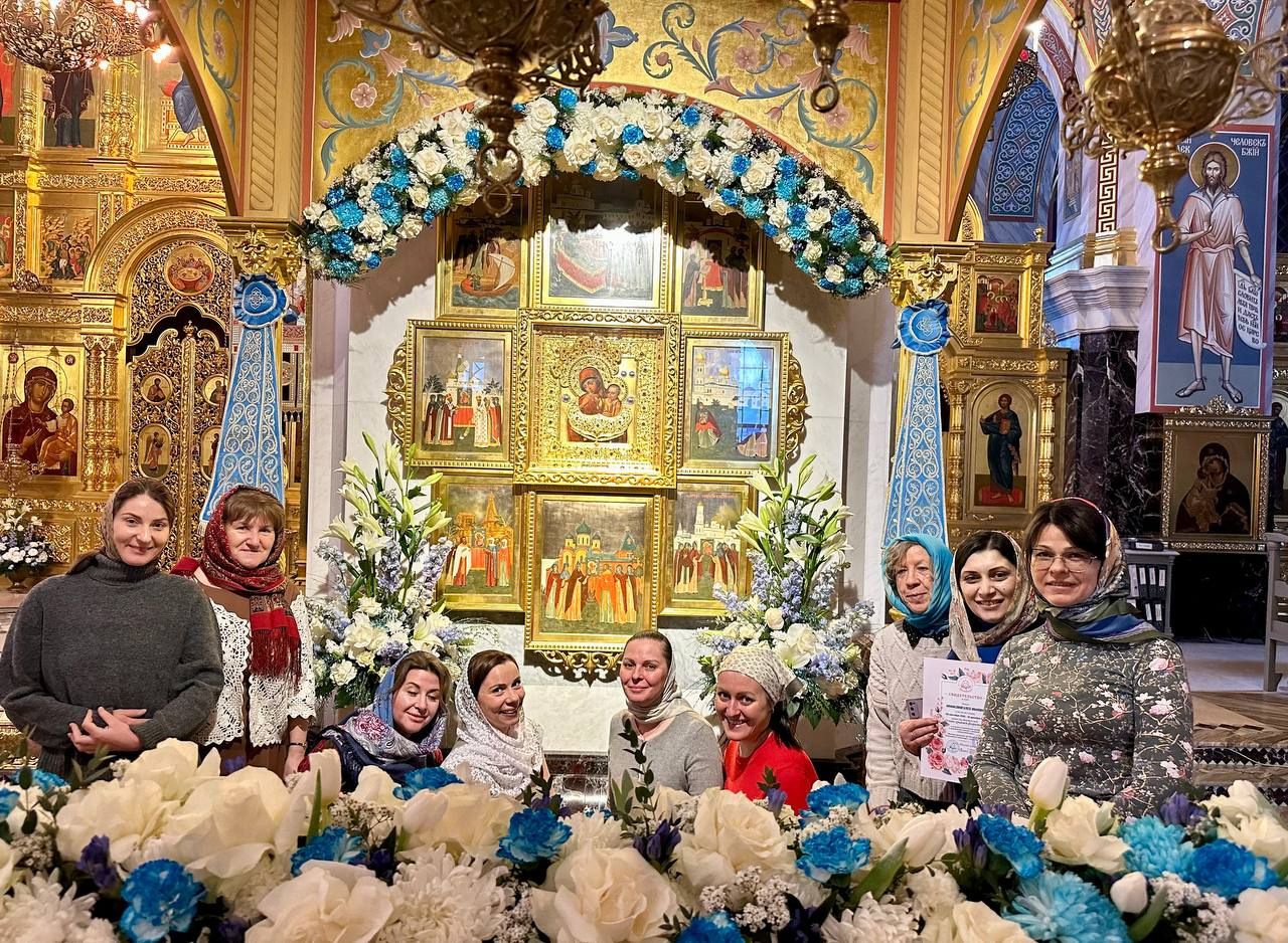 Ученицы курса у иконы, украшенной бело-голубыми цветами